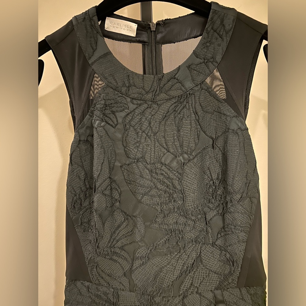 Stunning fitted upper body dress with full skirt detail. Incredibly flattering!